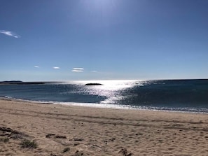 A beach with a clear sky, calm sea, and a distant island. - Exclusive Vila with private pool, wifi and air condition (Cambrils)