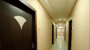 A hallway with a door labeled "209" and a tiled floor. - Hotel Amit Regency (Raipur)