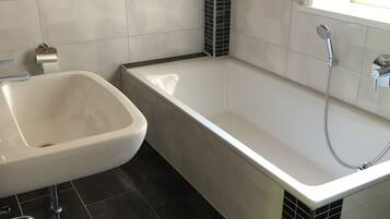A bathroom with a bathtub, a sink, and a toilet.