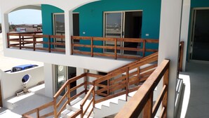 A multi-level building with wooden railings and a balcony. - B&B Sereia Azul (Boa Vista)