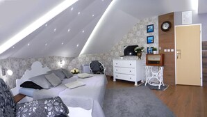 Een slaapkamer met een bed, een dressoir, een kaptafel en een televisie.