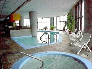 An indoor swimming pool with lounge chairs and a hot tub. - Luxury Condo in Spectacular Sugar Mountain North Carolina (Sugar Mountain)