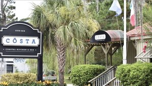 A coastal restaurant sign with 'COSTA' and 'COASTAL KITCHEN & BAR' written on it. - Beachfront/Pool Murrells/GardenCity/Surfside 
Wkly/MilitaryFirePoliceNurse Discs (Murrells Inlet)