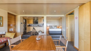 A modern, compact living space with a dining area, kitchenette, and a bedroom. - Nature Lover's Nest at the Foot of Table Mountain (Cape Town)
