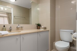 Shower, hair dryer, towels, toilet paper