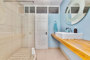 Shower, hair dryer, towels, toilet paper