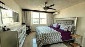 Relax in comfort with a large bed, dresser, and modern amenities.