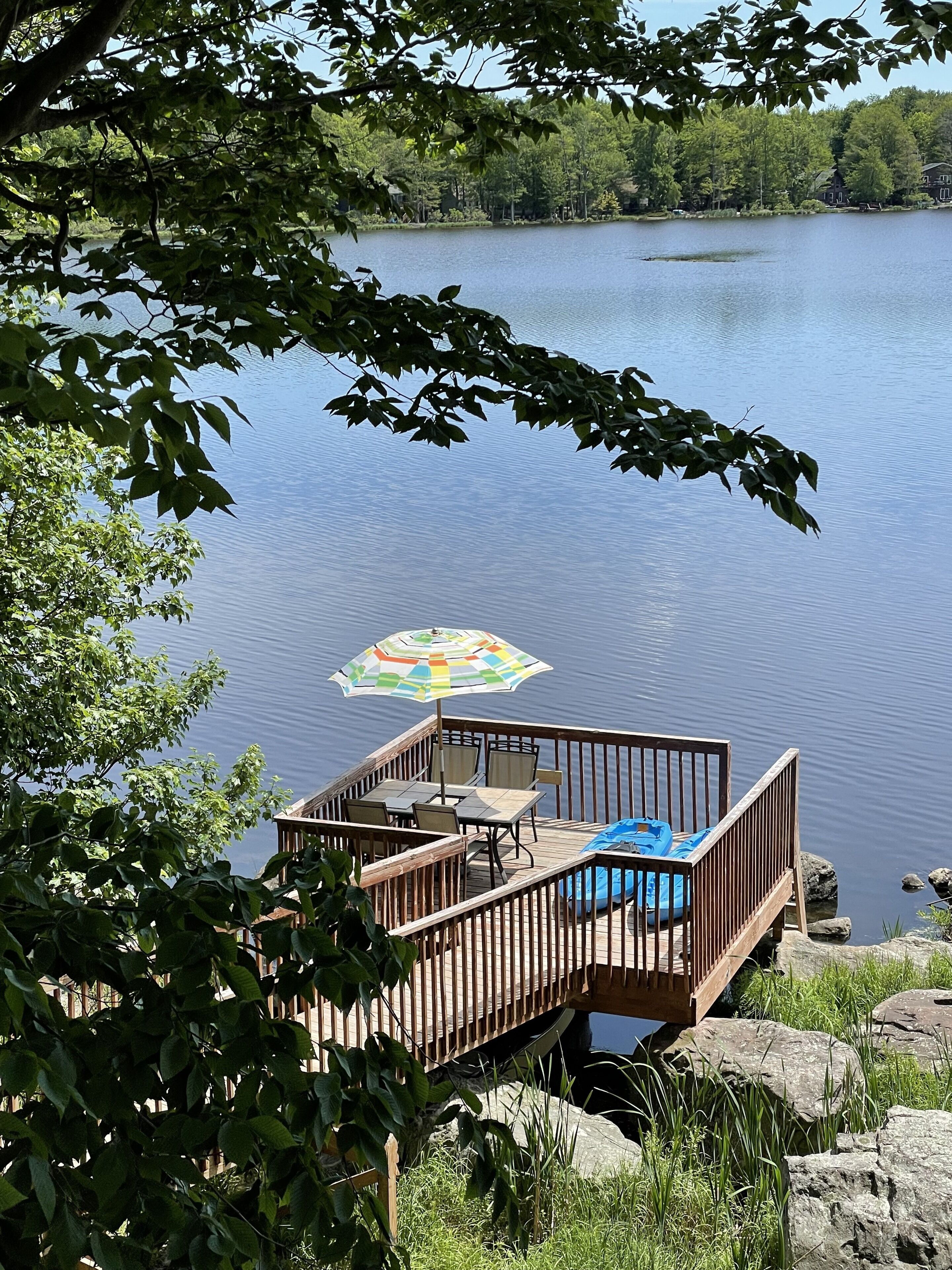 Beautiful Waterfront property with deck and boats close to ski and golf courses.