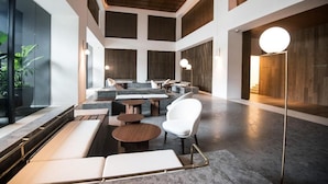 A spacious lobby with a high ceiling, modern seating arrangements, and large windows allowing natural light. - Cozy Family Suite Apartment (Kuala Lumpur)