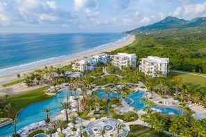 A resort with a large swimming pool, beachfront, and lush greenery. - Conrad Punta de Mita (Punta de Mita)