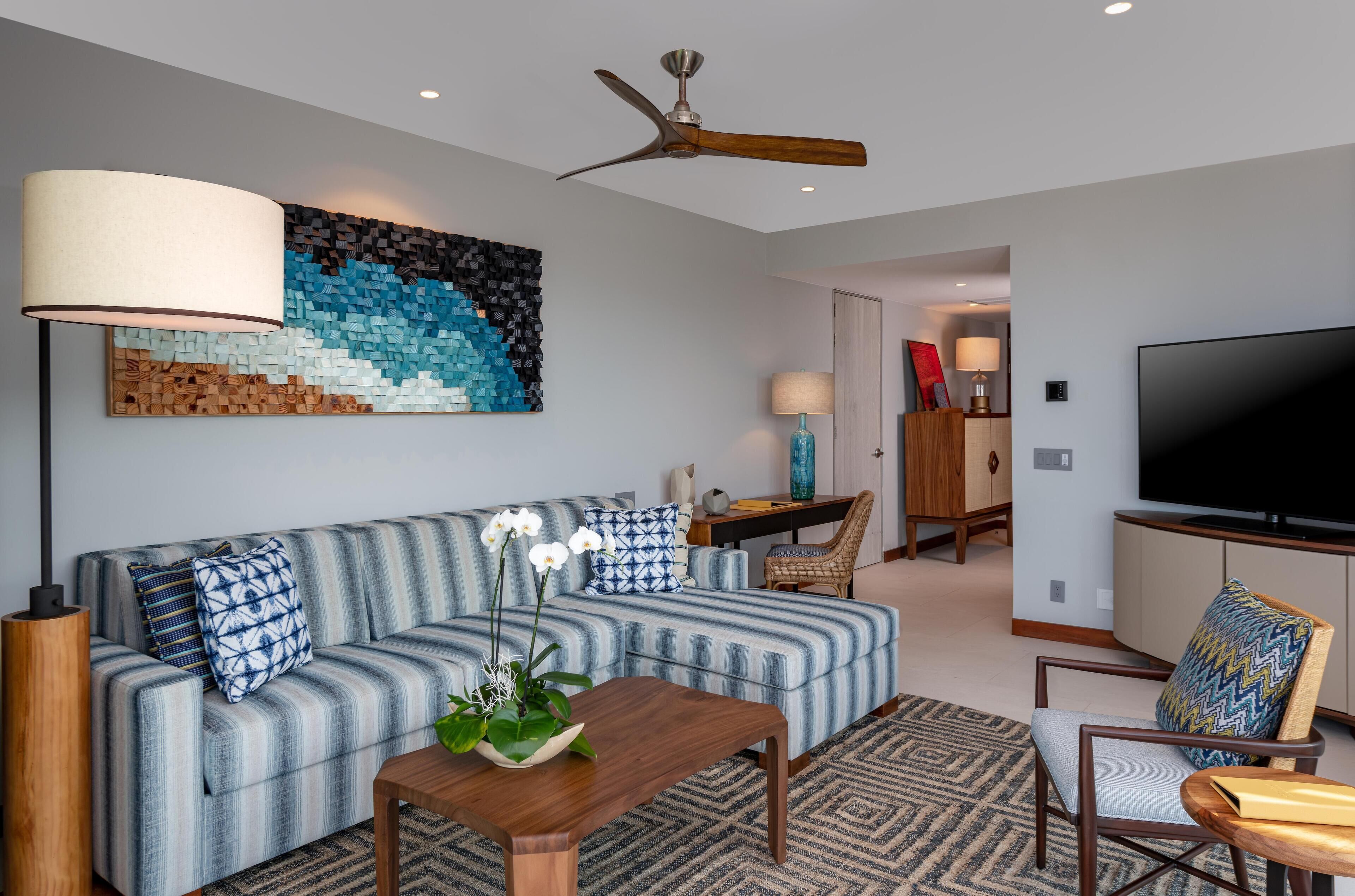 A modern living room with a sofa, coffee table, and TV.