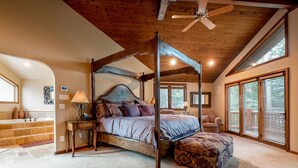 A four-poster bed with a canopy, a wooden ceiling, and a large window with blinds. - 3390 Sun Ridge Dr (Park City)