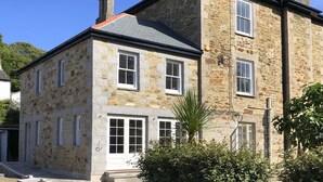 A stone building with multiple windows and a chimney. - A substantial six double bedroom property located in the heart of St Agnes. (St Agnes)