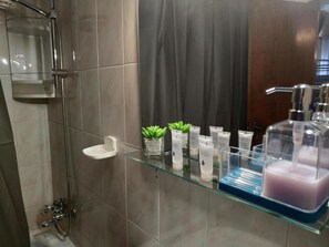 Separate bathtub and shower, hair dryer, towels, soap