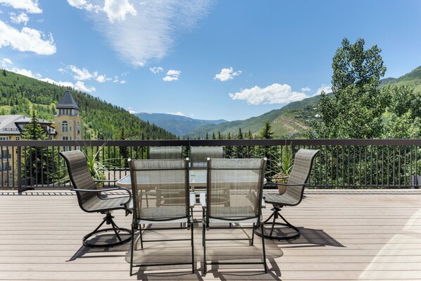 A deck with outdoor furniture overlooking a mountainous landscape. - 3 BR/3BA Platinum Vail /Lionshead Penthouse
4 min walk to Lionshead gondola! (Vail)