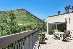 A balcony with a view of a mountainous landscape, a table with chairs, and a potted plant. - 3 BR/3BA Platinum Vail /Lionshead Penthouse
4 min walk to Lionshead gondola! (Vail)