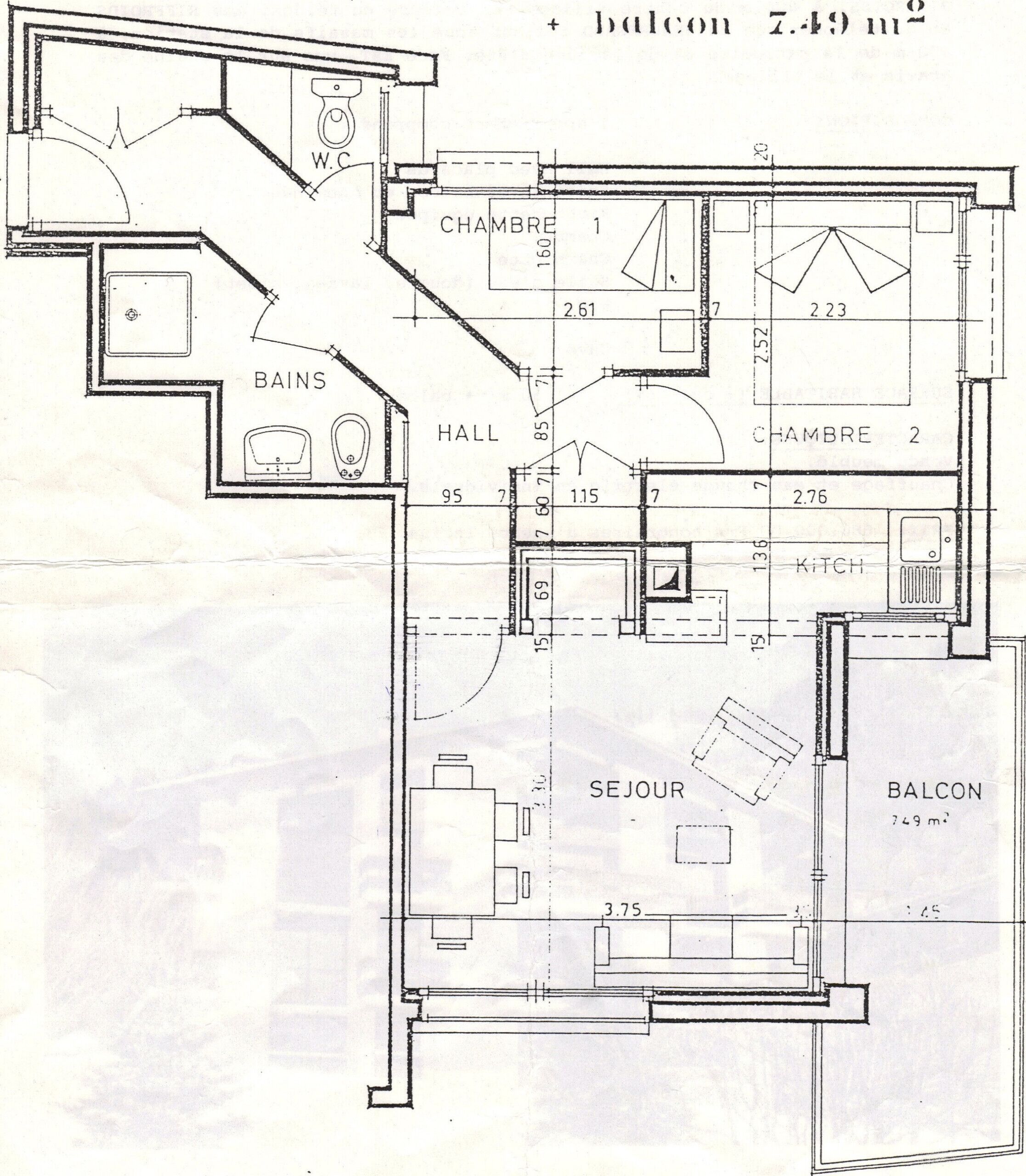 A floor plan of a hotel with two bedrooms, a kitchen, a bathroom, a living room, a balcony, and a stairwell.