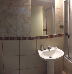 Deep-soaking bathtub, rainfall showerhead, hair dryer, towels