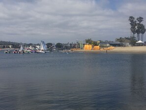 A marina with boats, a sandy beach, and palm trees in the background. - Tropical House! Prime location!   Two story with decks and bbq patio.  (San Diego)