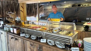 A buffet setup with various food items and condiments. - Deluxe Boutique Apartments Sonrisa Bonaire – Adults only (Kralendijk)