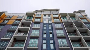 A multi-story building with a modern architectural design, featuring balconies and large windows. - VgoCameron Home (Tanah Rata)