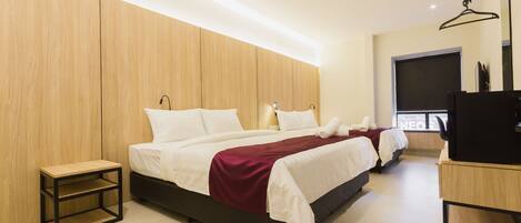 A modern bedroom with a large bed, a bedside table, and a TV.