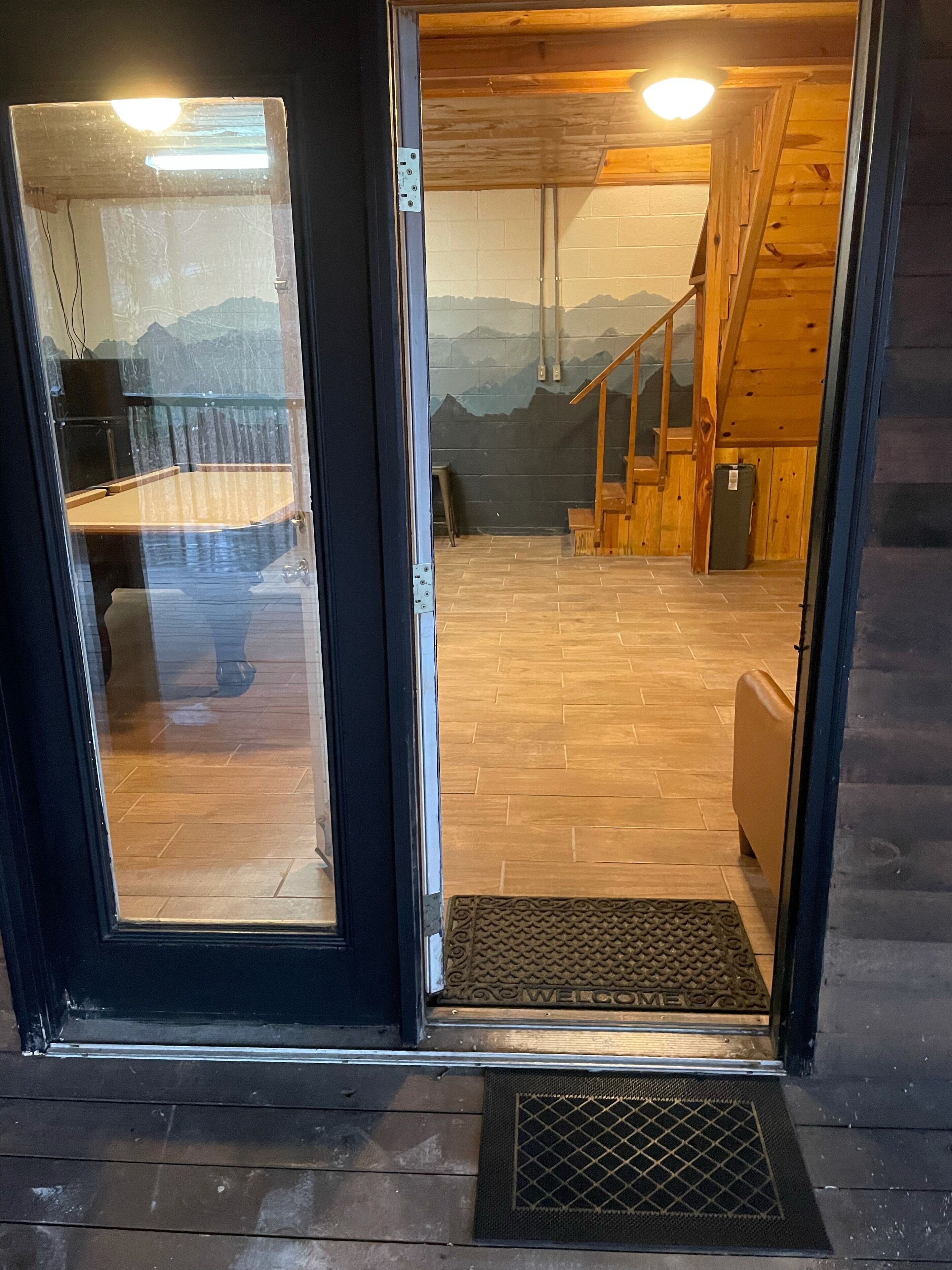 A wooden interior with a staircase leading to a balcony.