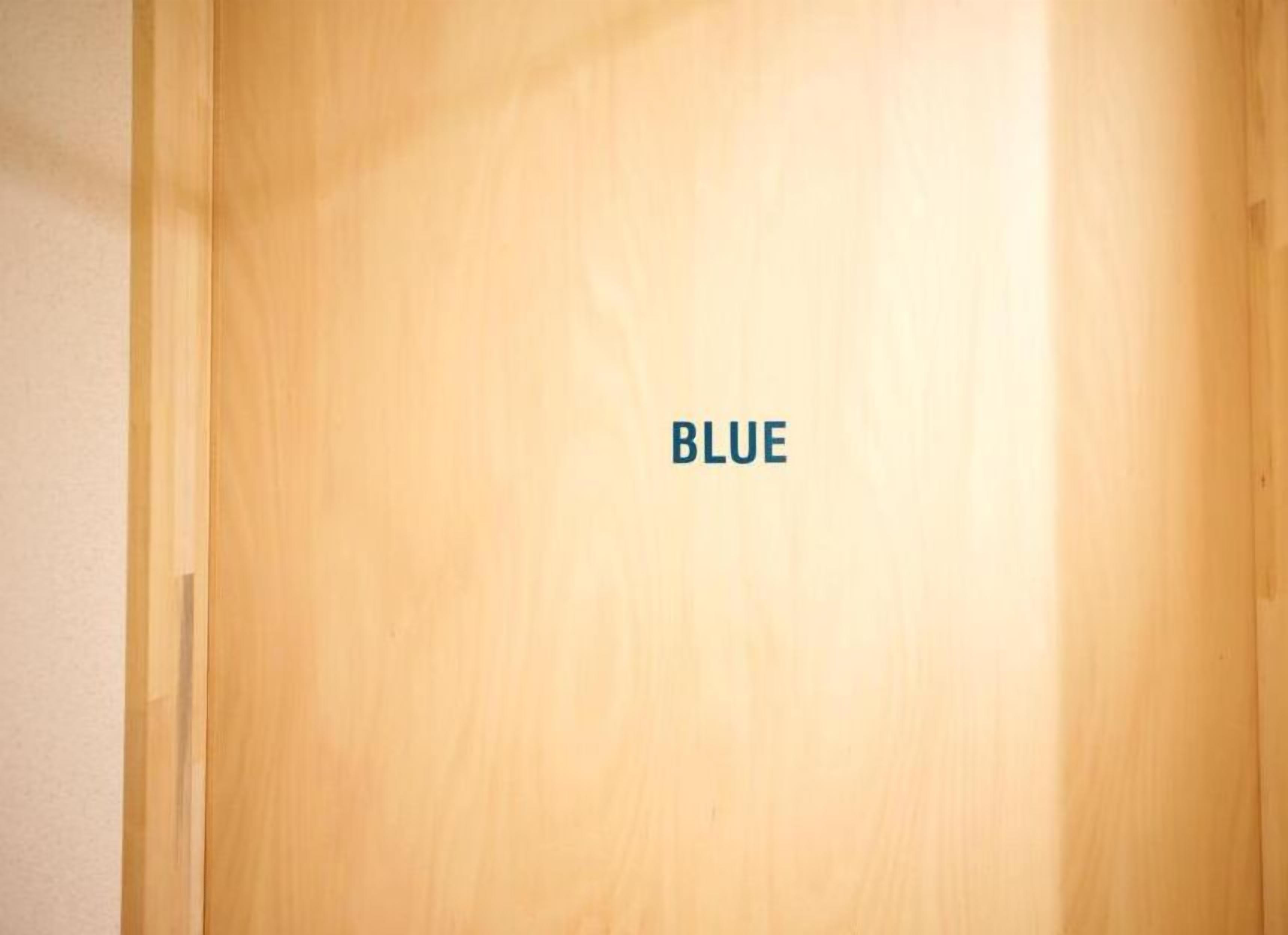 A wooden door with the word "BLUE" on it.