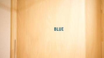 A wooden door with the word "BLUE" on it.