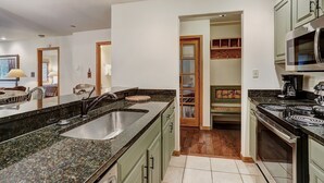 A kitchen with granite countertops, stainless steel appliances, and a walk-in pantry. - Newly Renovated 2 Bed/ 2 Bath Beaver Creek  2 Bedroom Condo by RedAwning (Avon)