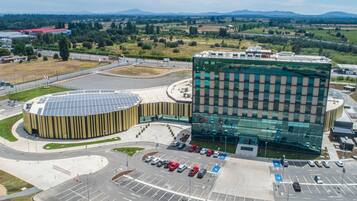 Un edificio moderno con fachada de vidrio y estructura circular con paneles solares.