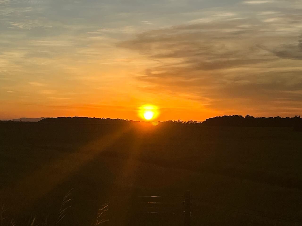 A sunset over a flat landscape with a clear horizon.