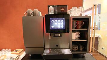 A coffee machine with a digital display and a coffee cup holder.