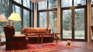 A room with a leather sofa, a wooden coffee table, and a small rug.
