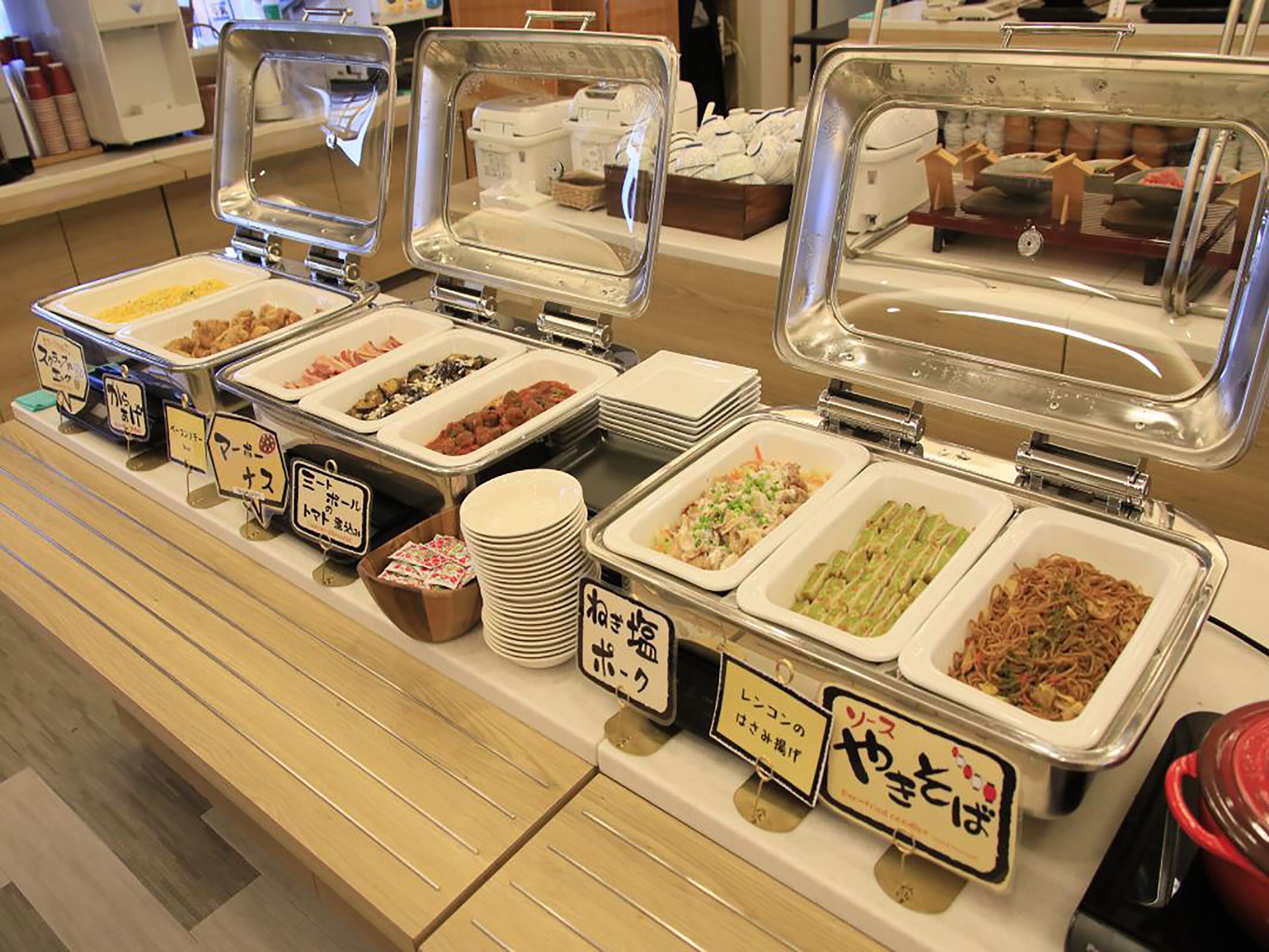 A buffet with various food items and clear signage in a restaurant setting.