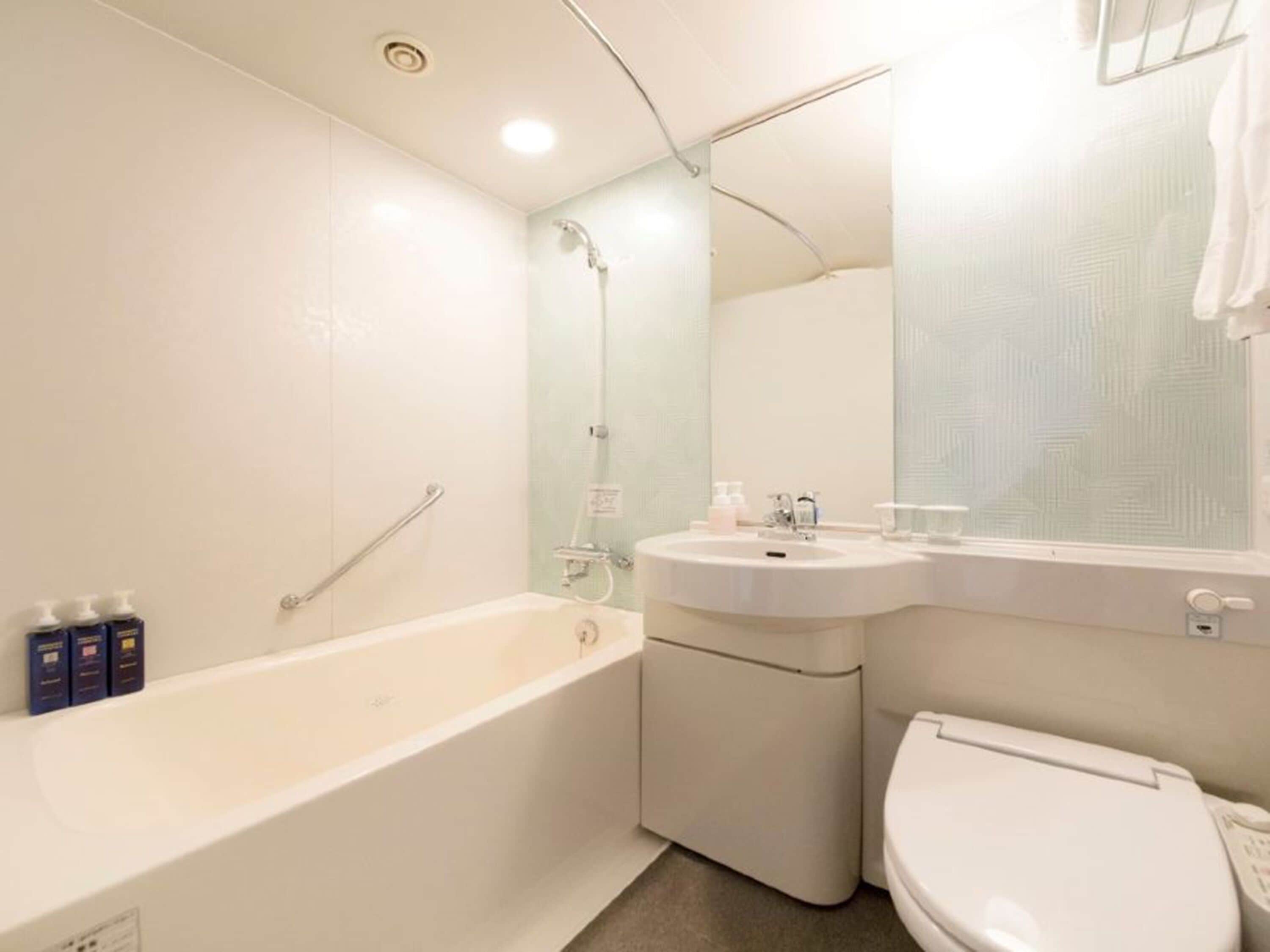 A bathroom with a bathtub, sink, and toilet.