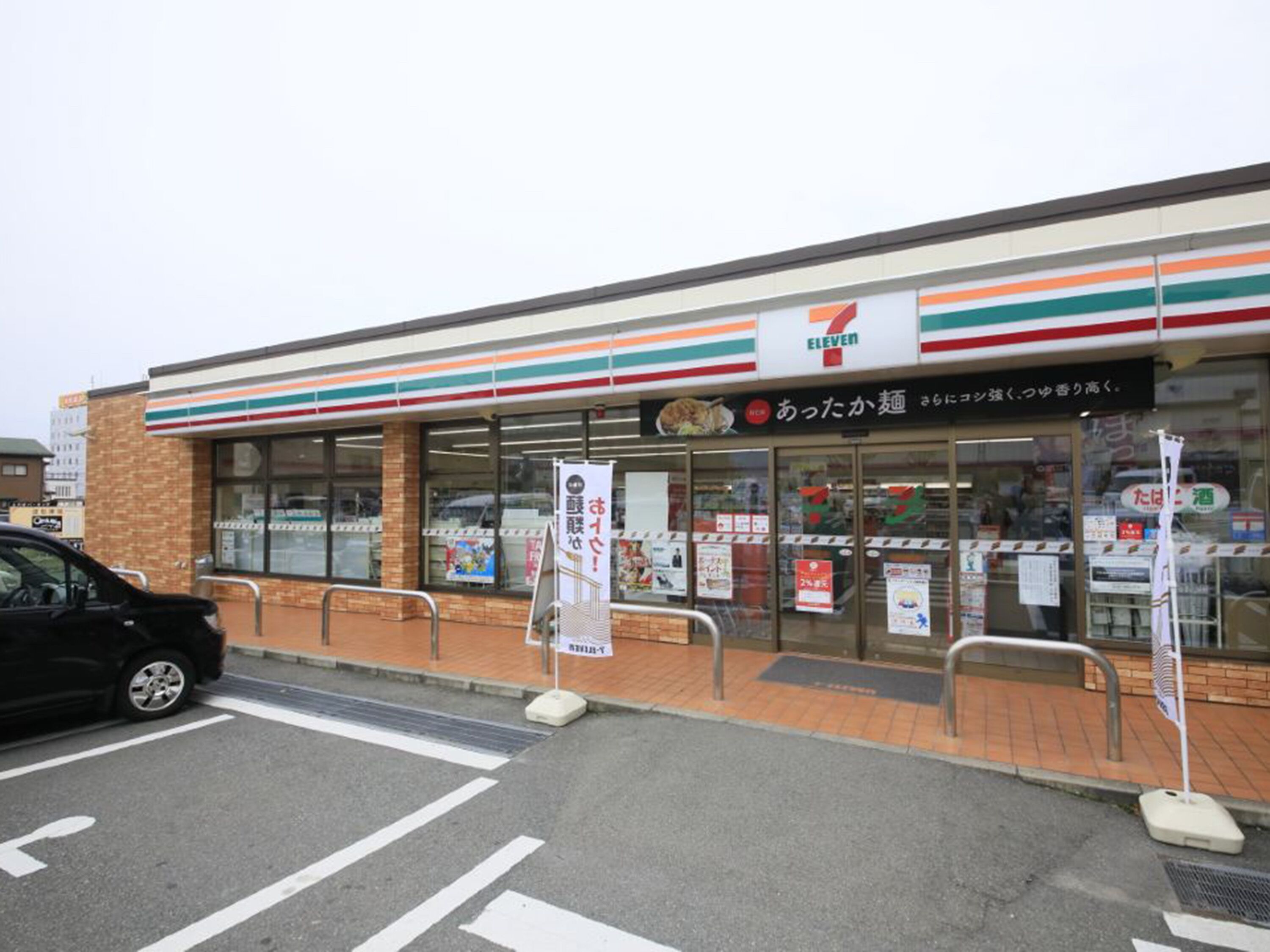 A 7-Eleven convenience store with a brick facade and large windows.