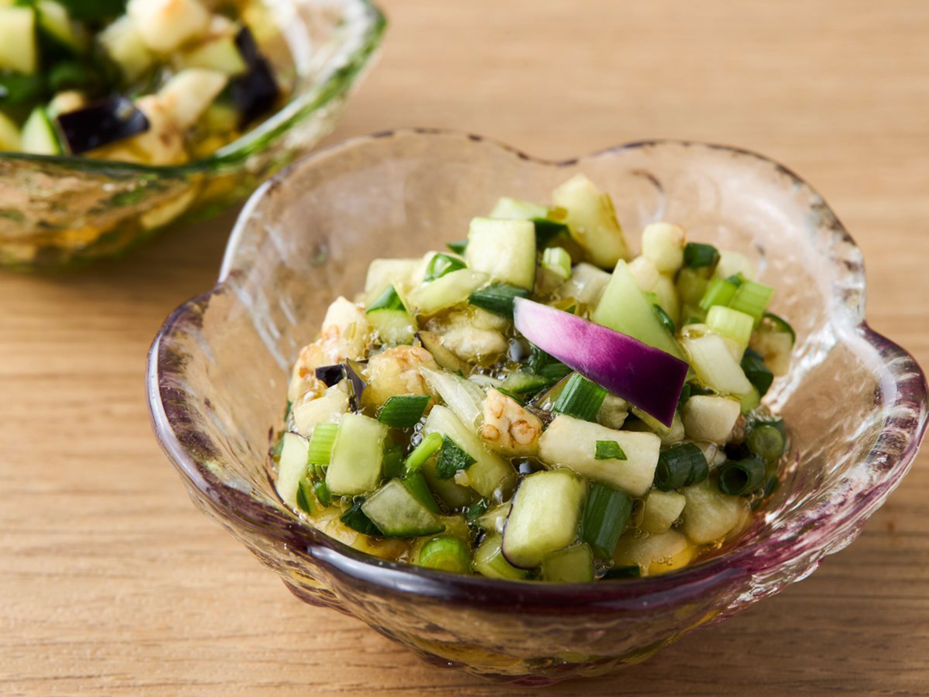 A glass bowl filled with a vegetable salad.