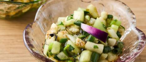 A glass bowl filled with a vegetable salad.