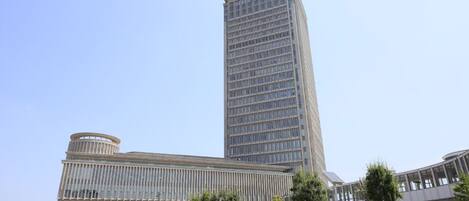 A modern building with a tall central section and a shorter base.