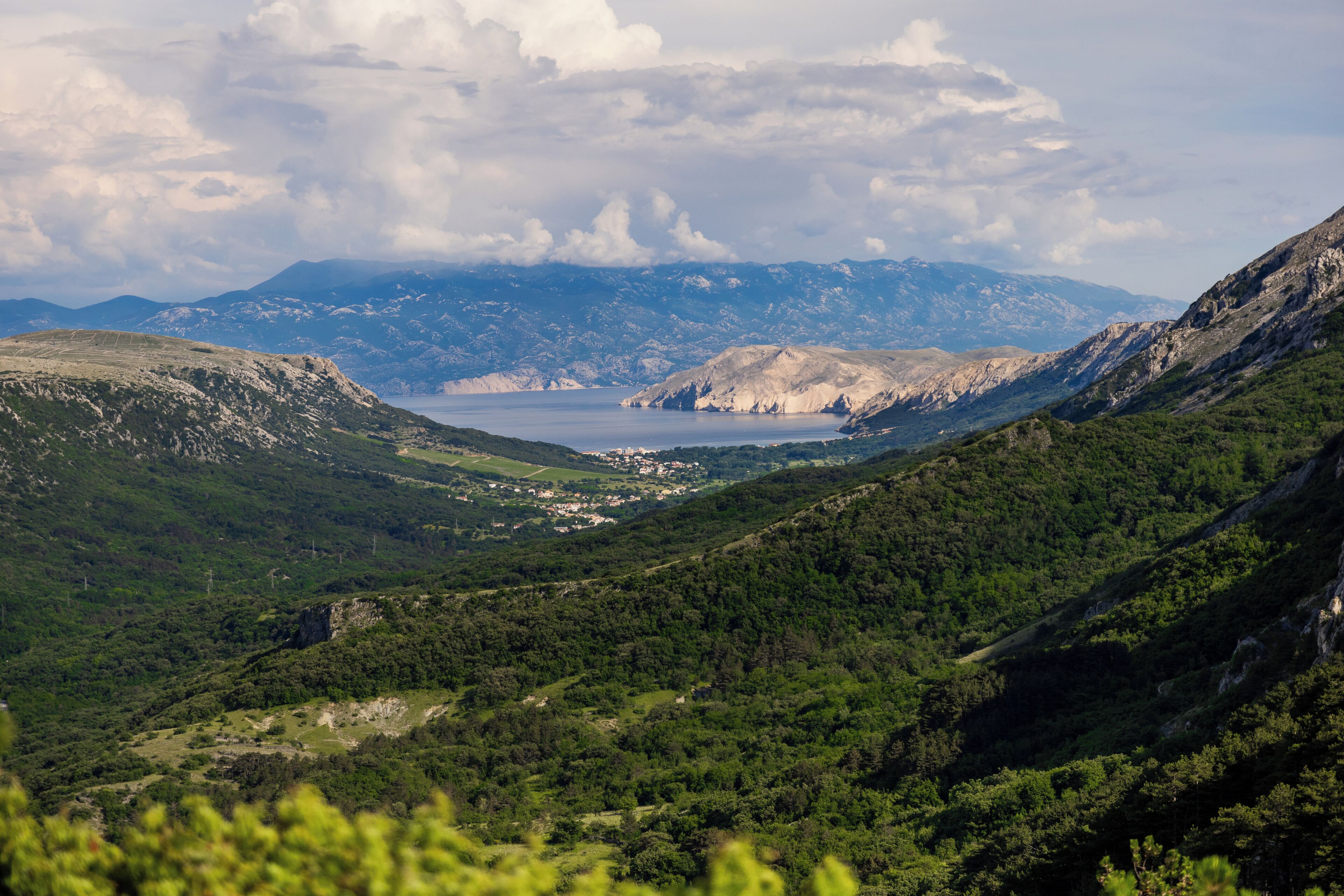 A mountainous landscape with a valley and a lake.