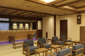 A traditional Japanese-style room with tatami mat flooring, wooden furniture, and a shoji screen. - Kotohira Onsen Onyado Shikishimakan (Kotohira)