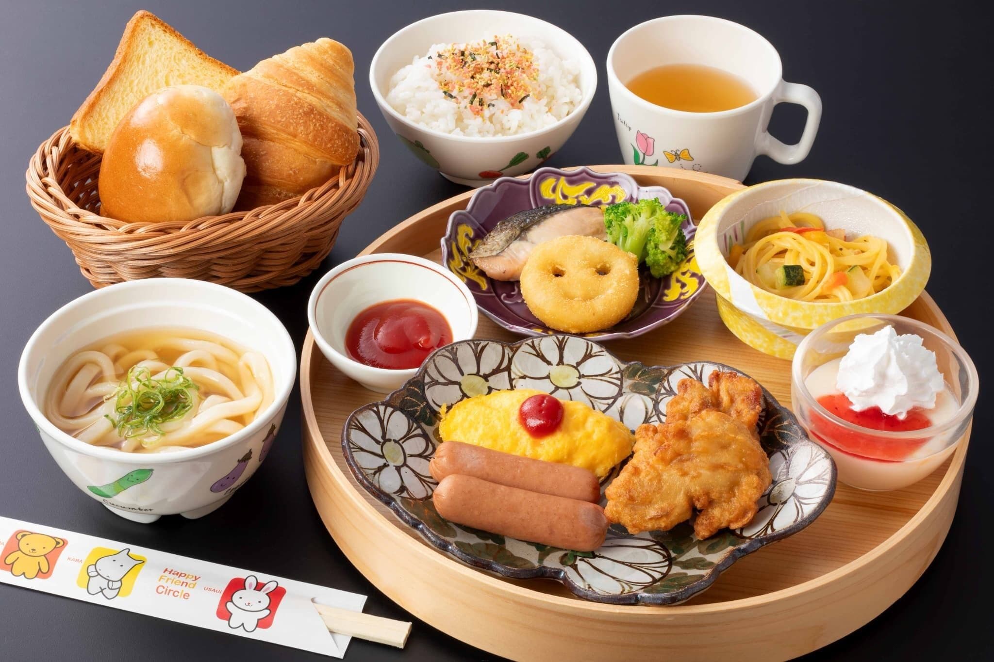 A variety of Japanese dishes including noodles, sushi, and tempura on a wooden tray.