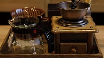 A coffee maker and a coffee pot on a wooden table.