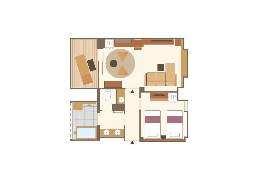 Un aménagement de chambre d’hôtel comprenant un espace salon, un coin repas, une salle de bain et une chambre à coucher.