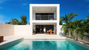 A modern two-story house with a swimming pool in front. - Sugar Kube Villa Turks & Caicos – Romantic 1BR Villa with Private Pool & Rooftop Deck (Grace Bay)