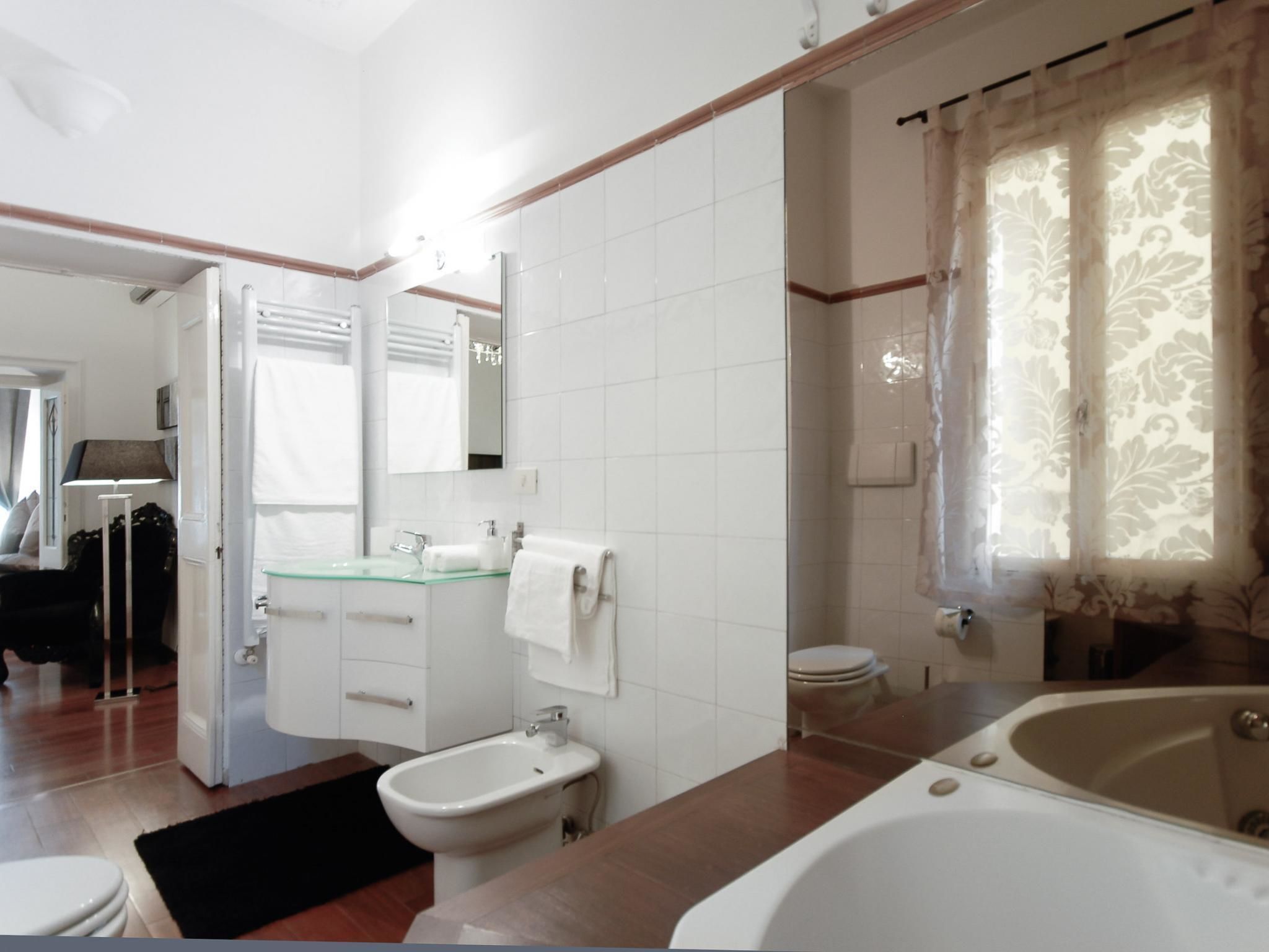 A modern bathroom with a bathtub, sink, and toilet.