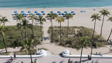 On the beach, white sand, sun-loungers, beach umbrellas