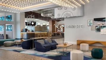 A modern interior with seating, a bar area, and a wall with the name 'Rivera'.