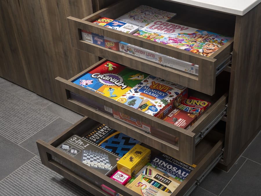 A wooden shelf with various board games and puzzles.
